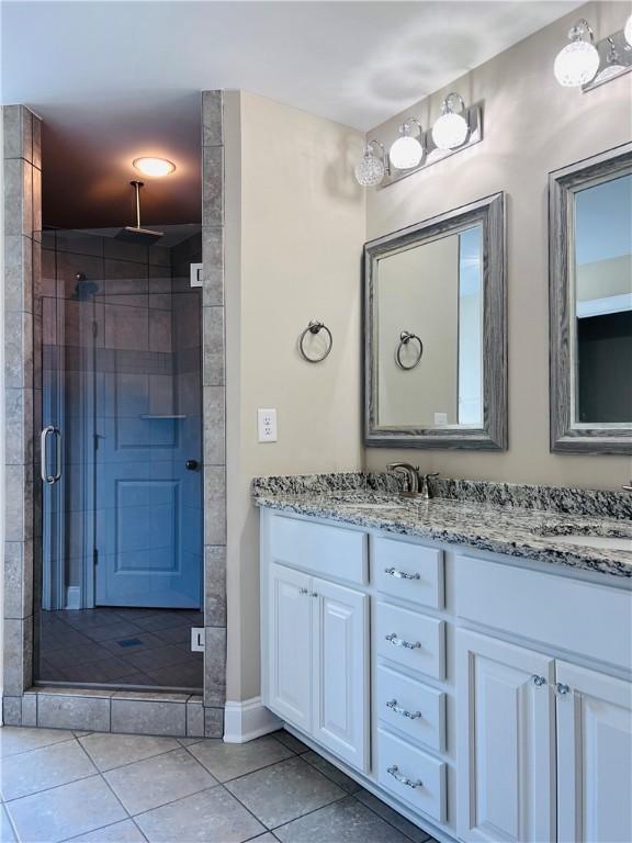 1024 Hampstead Ln, Opelika, AL 36801 - bathroom with double vanity, a stall shower, and tile patterned flooring