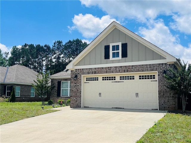 1024 Hampstead Ln, Opelika, AL 36801 - view of front of property featuring board and batten siding, driveway, brick siding, an attached garage, and a front lawn
