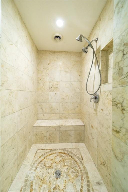 bathroom with a tile shower