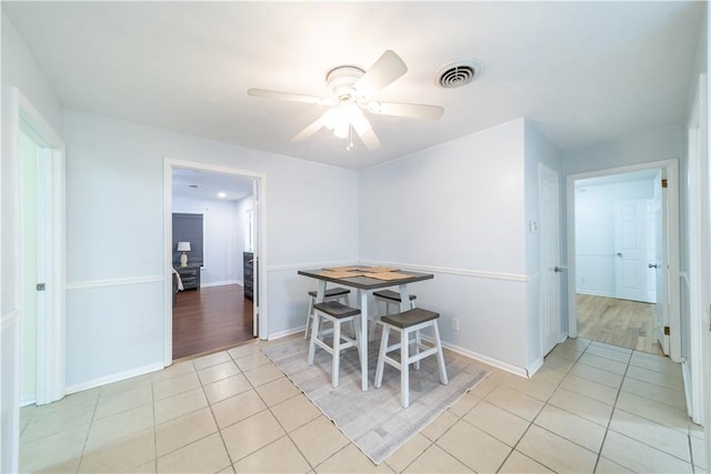 dining area with ceiling fan and light tile patterned floors