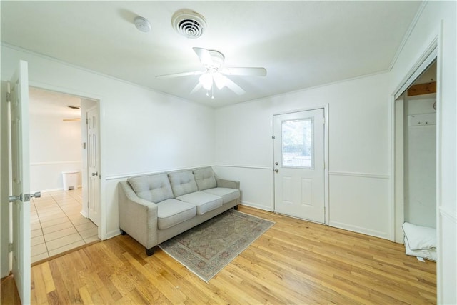 living room featuring light wood-type flooring and ceiling fan