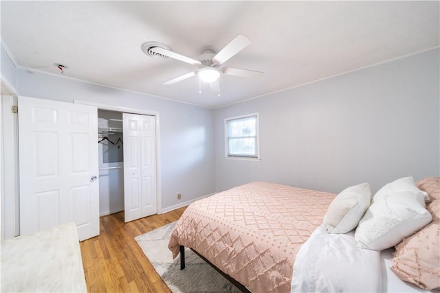 bedroom with light wood-type flooring, ceiling fan, and ornamental molding