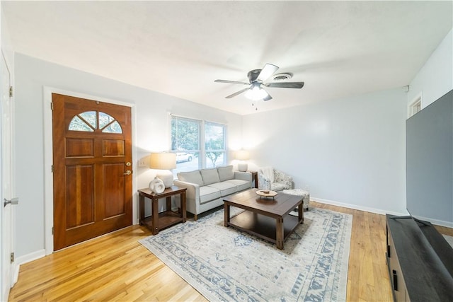 living room featuring hardwood / wood-style floors and ceiling fan