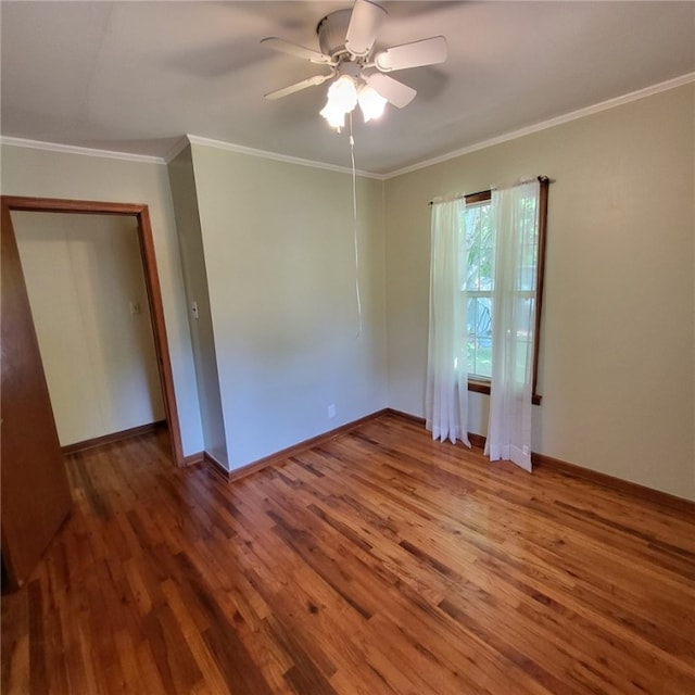 empty room with baseboards, ceiling fan, and wood finished floors