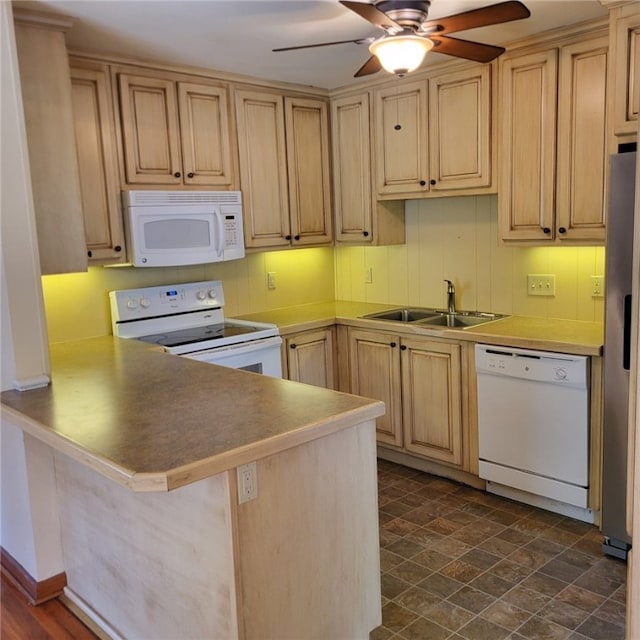 kitchen featuring a peninsula, light brown cabinets, white appliances, ceiling fan, and a sink