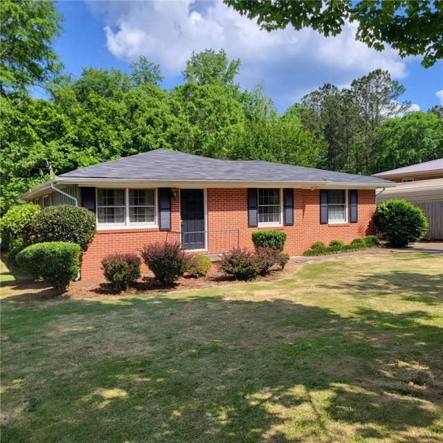 single story home with brick siding and a front lawn