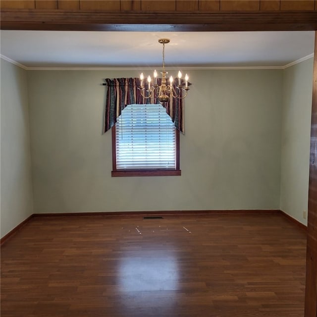 unfurnished room with an inviting chandelier, baseboards, crown molding, and wood finished floors