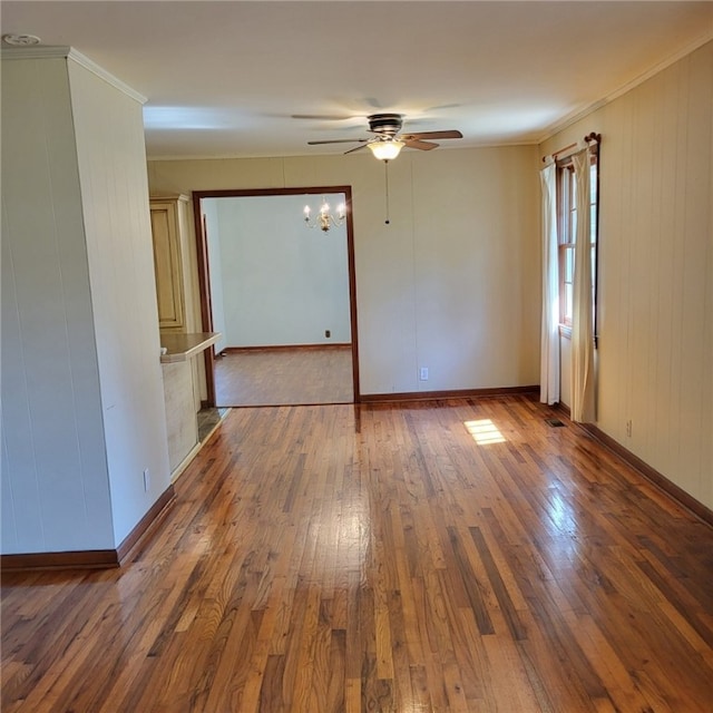 unfurnished room with ceiling fan, ornamental molding, baseboards, and hardwood / wood-style flooring