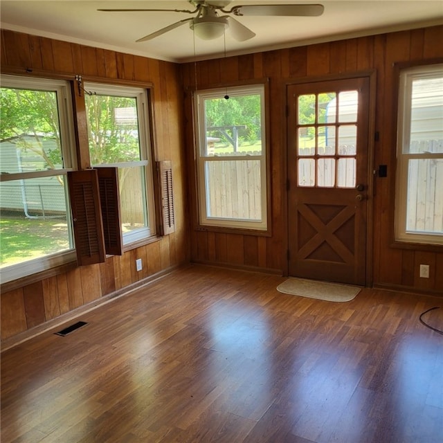 unfurnished sunroom featuring visible vents