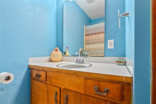 bathroom with a shower with curtain and vanity