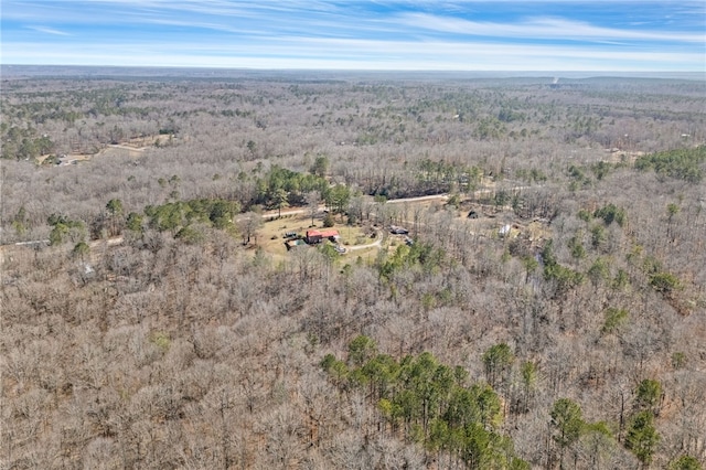 birds eye view of property featuring a wooded view