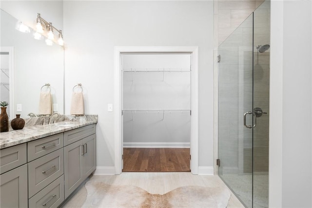 bathroom featuring vanity and an enclosed shower