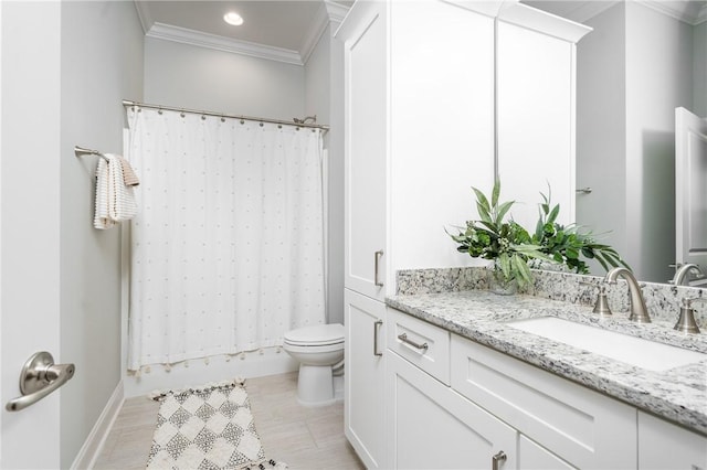 bathroom featuring crown molding, vanity, and toilet