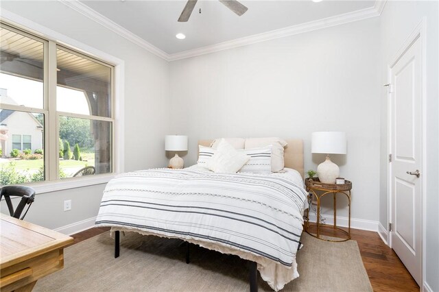 bedroom featuring hardwood / wood-style floors, ceiling fan, and crown molding