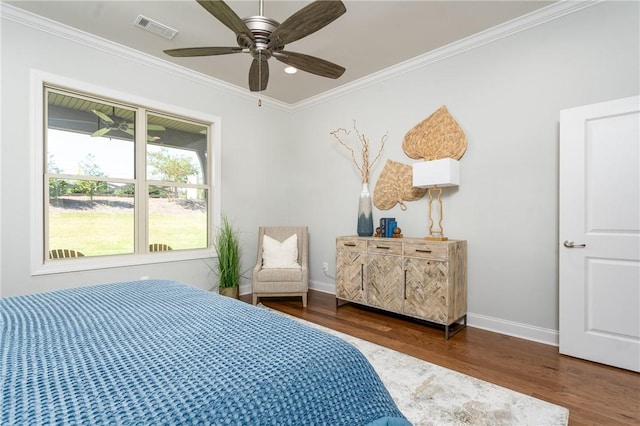 bedroom featuring ceiling fan, dark hardwood / wood-style flooring, and crown molding