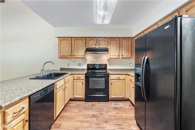 283 Ivy Ln, Auburn, AL 36830 - kitchen with black appliances, under cabinet range hood, light wood-type flooring, and light brown cabinets