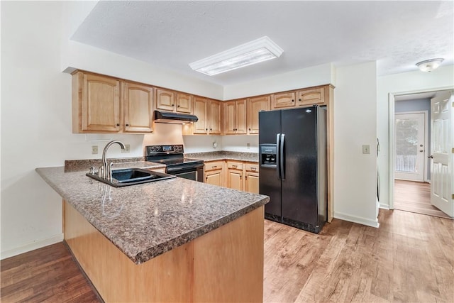283 Ivy Ln, Auburn, AL 36830 - kitchen featuring black appliances, under cabinet range hood, a peninsula, light wood finished floors, and light brown cabinetry