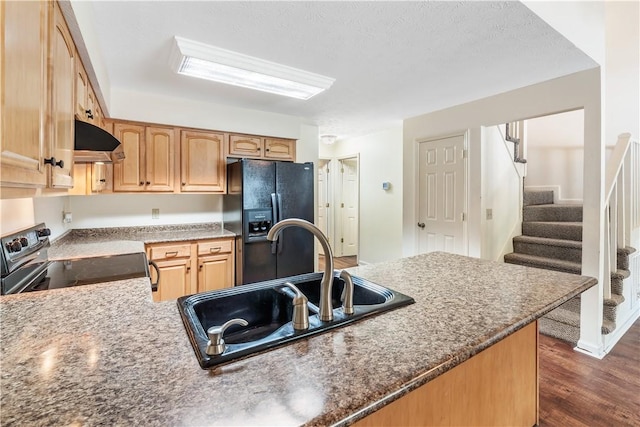 283 Ivy Ln, Auburn, AL 36830 - kitchen featuring black appliances, extractor fan, dark wood finished floors, a peninsula, and dark stone countertops