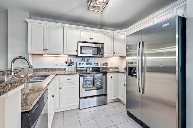277 S Gay St Unit 601, Auburn, AL 36830 - kitchen featuring light tile patterned flooring, white cabinetry, a sink, and stainless steel appliances