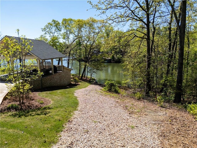 view of yard featuring a water view, a gazebo, and gravel driveway