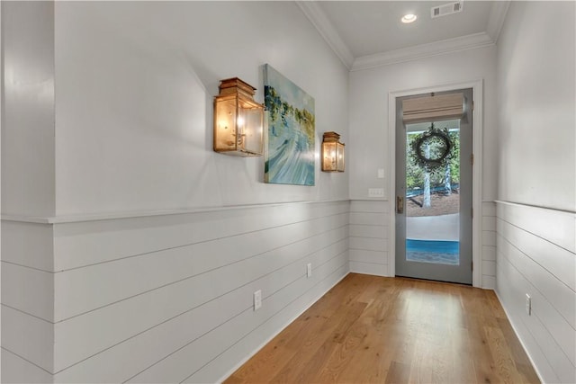 entryway with ornamental molding, recessed lighting, visible vents, and wood finished floors