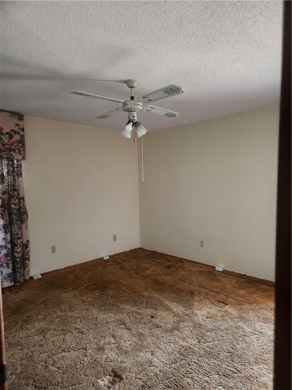 spare room featuring carpet, a ceiling fan, and a textured ceiling