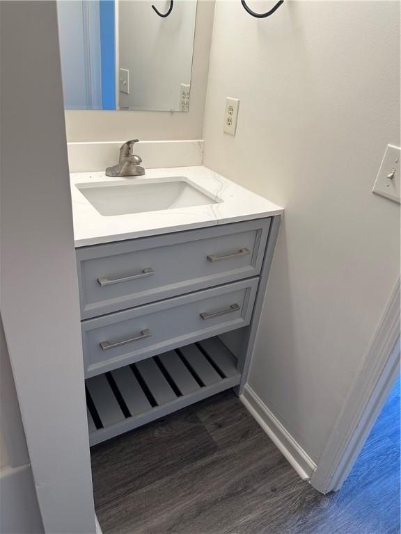 bathroom with vanity and hardwood / wood-style flooring