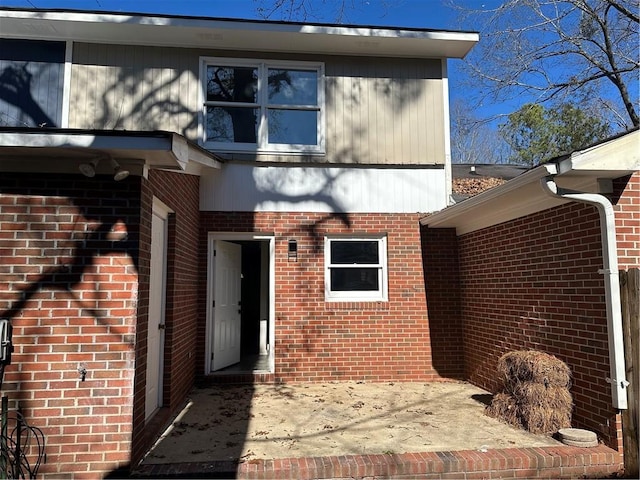 view of exterior entry featuring a patio