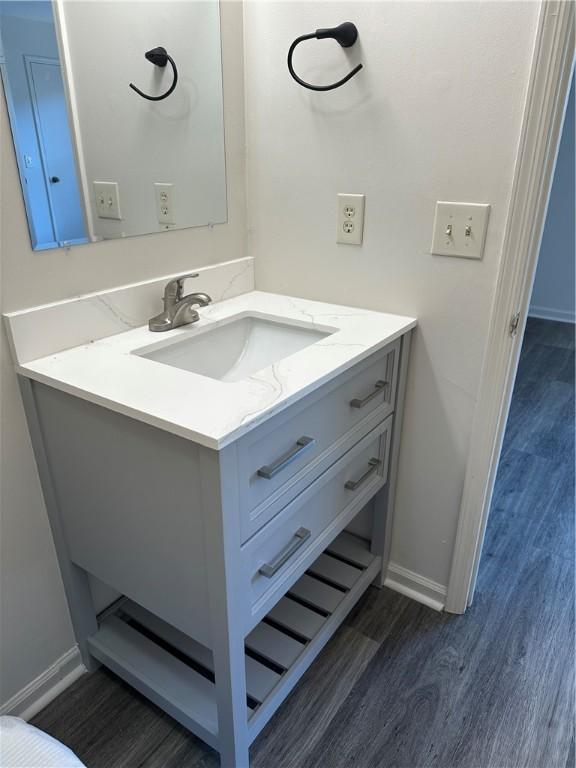 bathroom featuring wood-type flooring and vanity