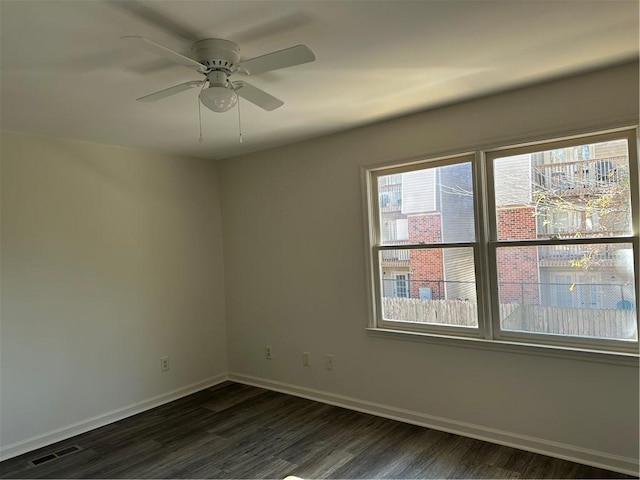 unfurnished room featuring ceiling fan and dark hardwood / wood-style flooring