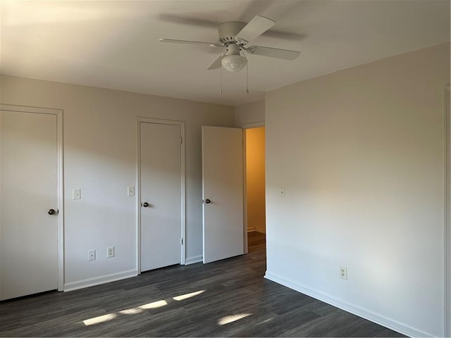 unfurnished bedroom featuring ceiling fan and dark wood-type flooring