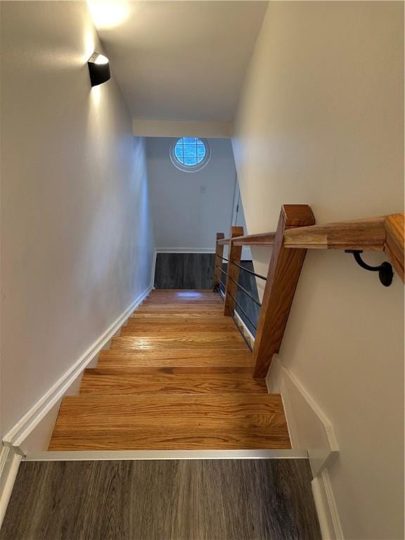 stairs featuring hardwood / wood-style flooring