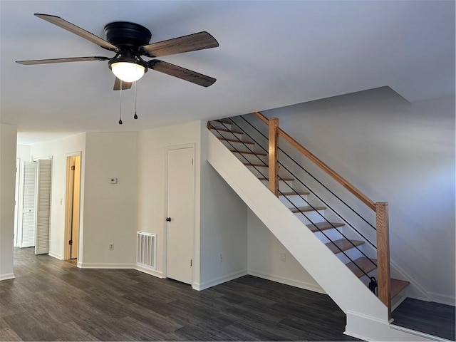 staircase with hardwood / wood-style flooring and ceiling fan