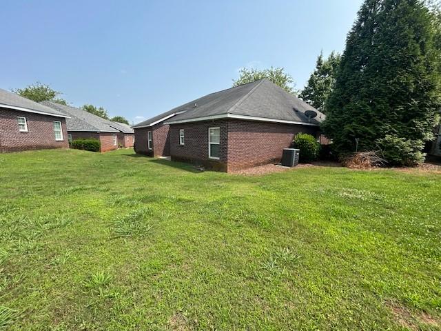 807 W Longleaf Dr Unit 92, Auburn, AL 36832 - view of property exterior with a lawn, central AC, and brick siding