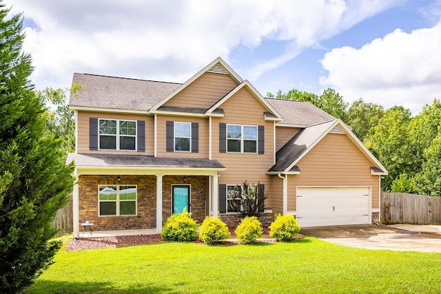 craftsman-style house featuring a garage, a front yard, and a porch