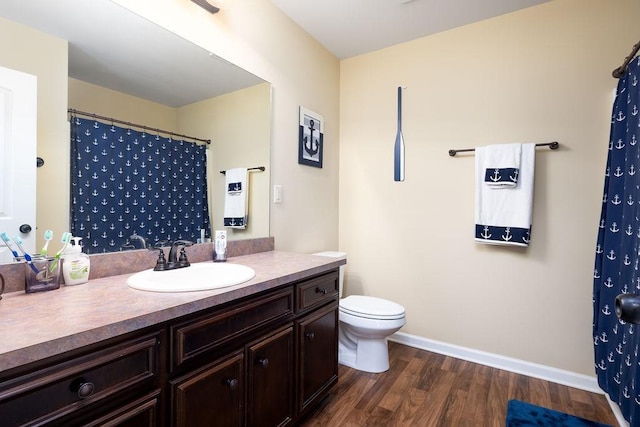 bathroom featuring vanity, hardwood / wood-style floors, and toilet