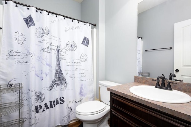 bathroom with vanity, curtained shower, and toilet