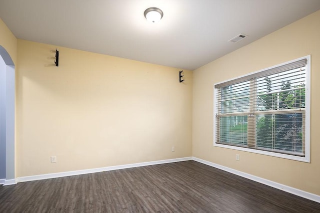 empty room with dark wood-type flooring