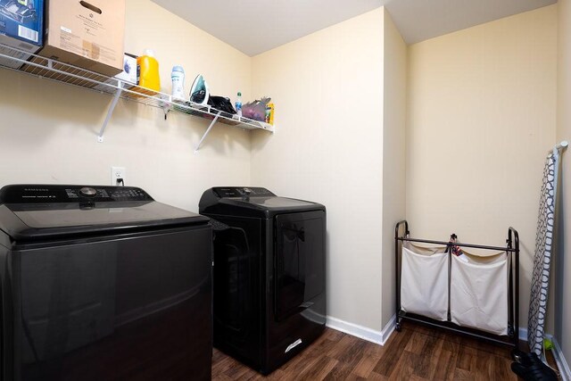 laundry room with dark hardwood / wood-style flooring and independent washer and dryer