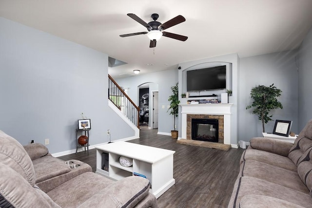 living room with a fireplace, dark hardwood / wood-style floors, and ceiling fan