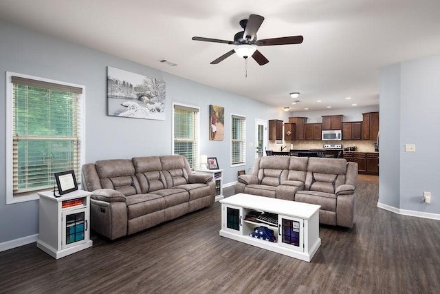 living room featuring dark hardwood / wood-style floors and ceiling fan