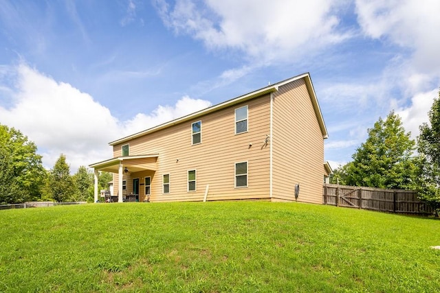 back of house featuring a yard