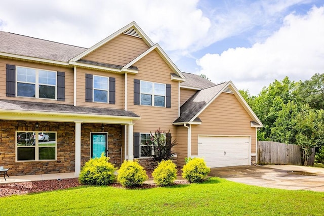 view of front of house featuring a garage and a front lawn