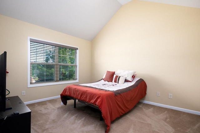 carpeted bedroom featuring lofted ceiling