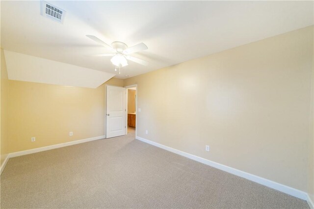 carpeted empty room featuring ceiling fan and lofted ceiling