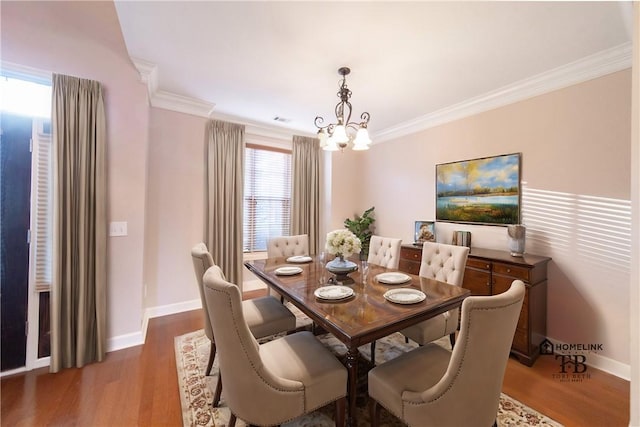 dining room featuring crown molding, dark hardwood / wood-style floors, and a notable chandelier