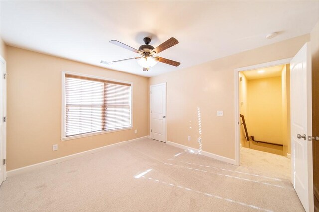 unfurnished bedroom with ceiling fan and light carpet