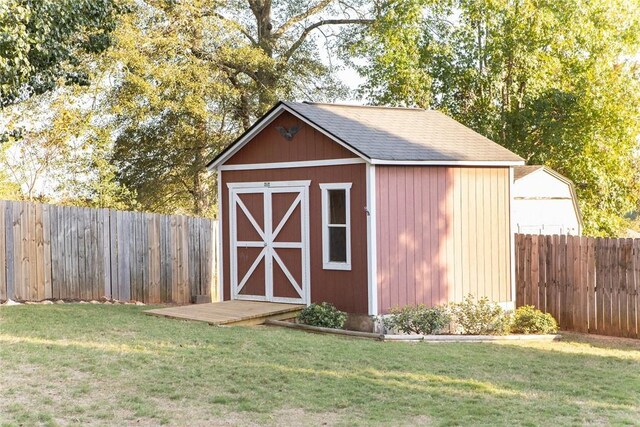 view of outbuilding featuring a yard