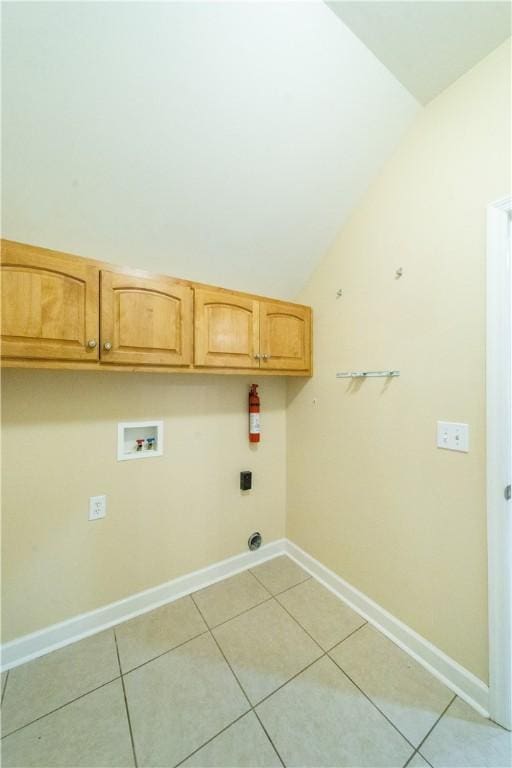 laundry area with cabinets, hookup for a washing machine, and light tile patterned floors