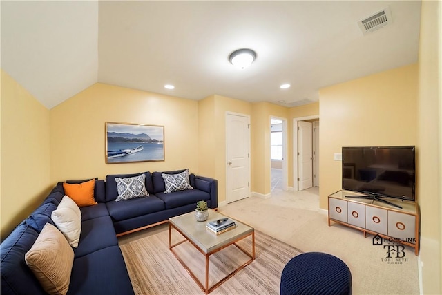 carpeted living room featuring lofted ceiling